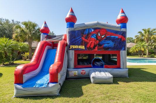 Spider-Man themed inflatable bounce house with slide in a backyard setting.