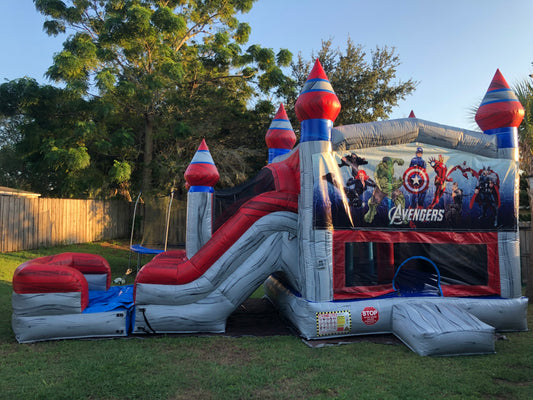 Avengers inflatable playground structure on grass with trees in the background